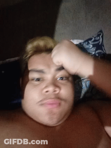 Shirtless Man Laying On Bed With Blue And White Pillow GIF