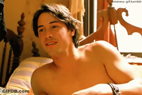 Shirtless Man Laying On Bed With Striped Pillow GIF