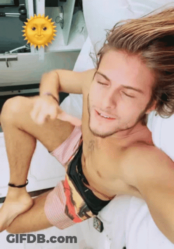 Shirtless Man Laying On Bed With Sun Face GIF