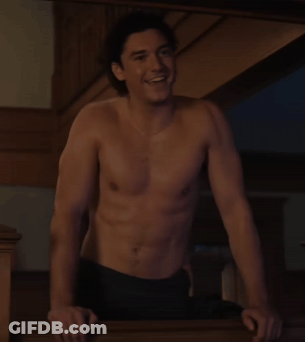 Shirtless Man Leaning On Railing Smiling GIF