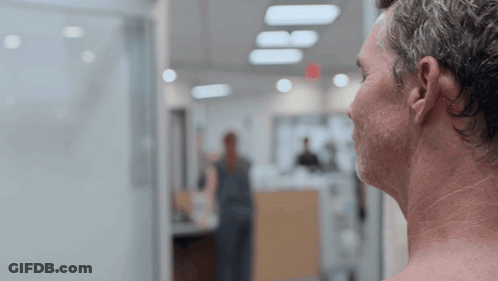 Shirtless Man Looking Out Window GIF