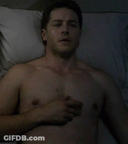 Shirtless Man Lying In Bed With Hand On Chest GIF
