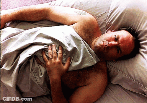 Shirtless Man Lying In Bed With Ring GIF