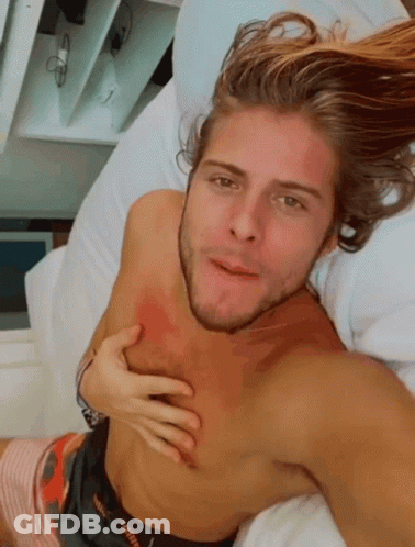 Shirtless Man Lying On Bed Hand On Chest GIF