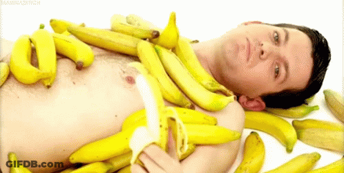 Shirtless Man Lying On Pile Of Bananas GIF