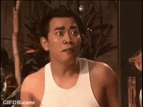 Shirtless Man Making Funny Face In Front Of Plant GIF