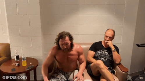 Shirtless Man Next To Another Man On Couch GIF