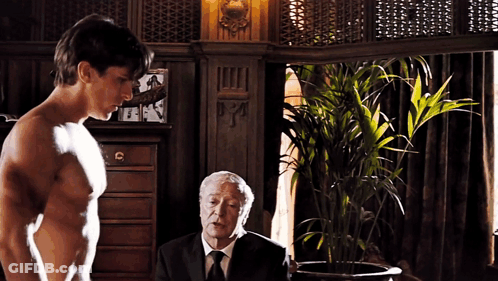 Shirtless Man Next To Older Man In Suit GIF