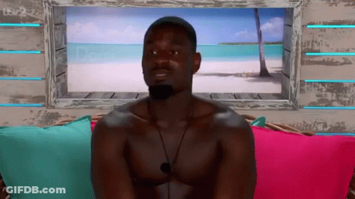 Shirtless Man On Couch By Beach Picture Window GIF