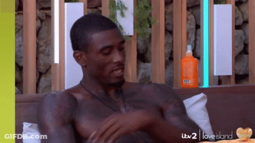 Shirtless Man On Couch With Sunscreen GIF
