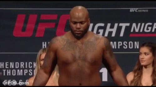 Shirtless Man On Scale With Two Women Watching GIF