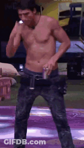Shirtless Man On Stage Holding Can Of Soda GIF