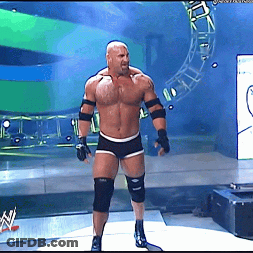 Shirtless Man On Stage In Front Of WWE Sign GIF