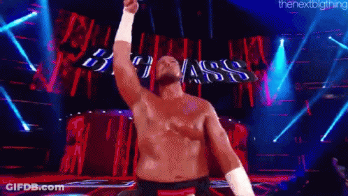 Shirtless Man On Stage With Arm Raised GIF