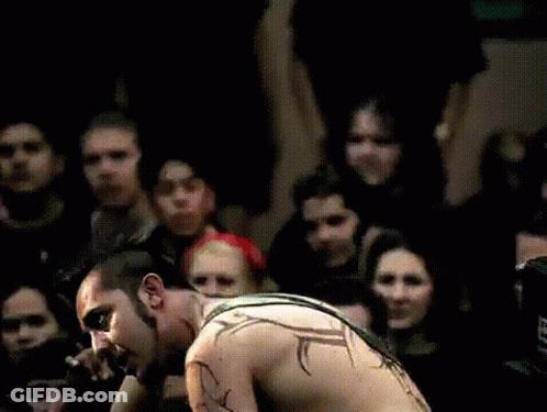 Shirtless Man Playing Guitar For Crowd GIF