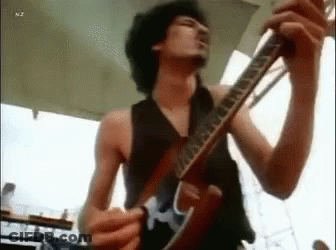 Shirtless Man Playing Guitar On Stage GIF