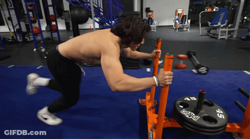 Shirtless Man Pushing Barbell With 45 Plate GIF