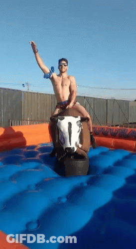 Shirtless Man Riding Mechanical Bull GIF