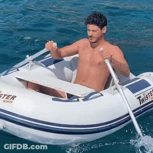 Shirtless Man Rowing Twister Boat In Ocean GIF