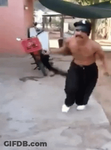 Shirtless Man Running In Front Of Red Scooter GIF