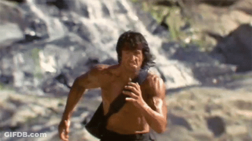 Shirtless Man Running In Front Of Waterfall GIF