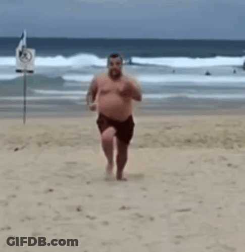 Shirtless Man Running On Beach GIF