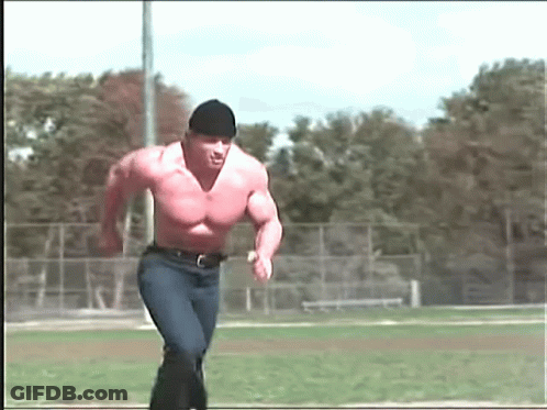 Shirtless Man Running On Field With Trees GIF