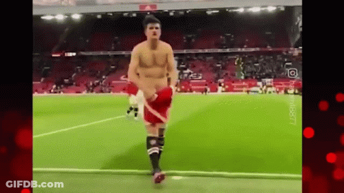 Shirtless Man Running On Soccer Field GIF
