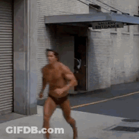 Shirtless Man Running Past Gallery Entrance Sign GIF