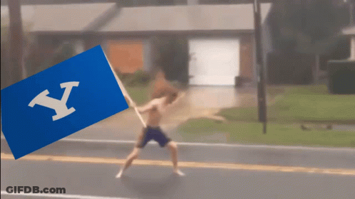Shirtless Man Running With Blue Flag Letter Y GIF