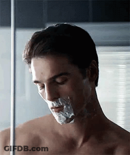 Shirtless Man Shaving Face With Razor GIF