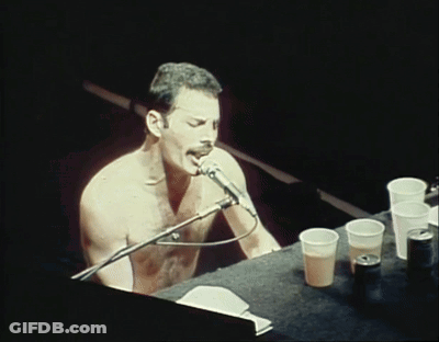 Shirtless Man Singing Into Microphone GIF