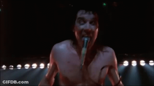 Shirtless Man Singing Into Microphone GIF