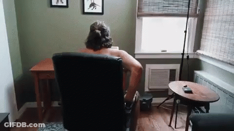 Shirtless Man Sitting In Living Room Chair GIF