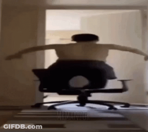 Shirtless Man Sitting In Office Chair With Arms Outstretched GIF