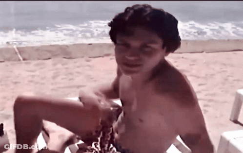 Shirtless Man Sitting On Beach Chair GIF