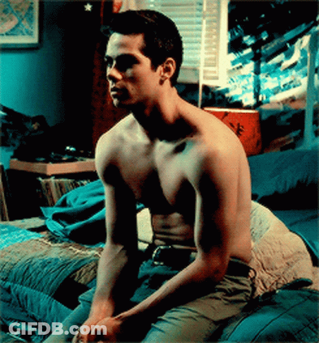 Shirtless Man Sitting On Bed Hands On Knees GIF