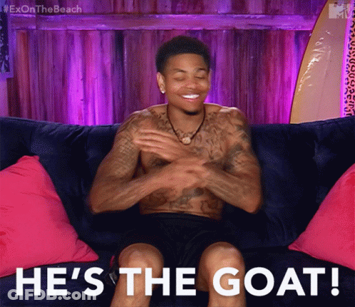 Shirtless Man Sitting On Couch He's The Goat GIF