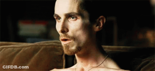 Shirtless Man Sitting On Couch With Mouth Open GIF
