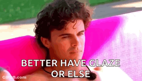 Shirtless Man Sitting On Pink Couch With Microphone And Pink Pillow GIF