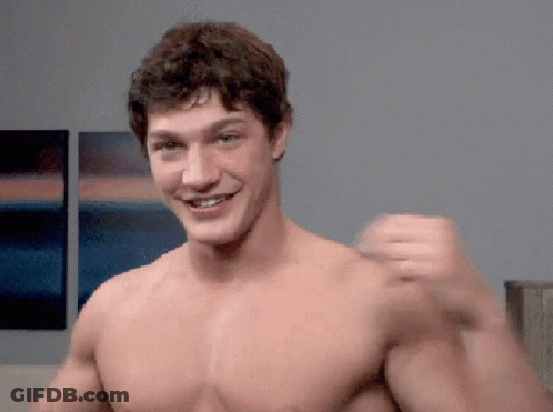 Shirtless Man Smiling And Flexing In Front Of Paintings GIF