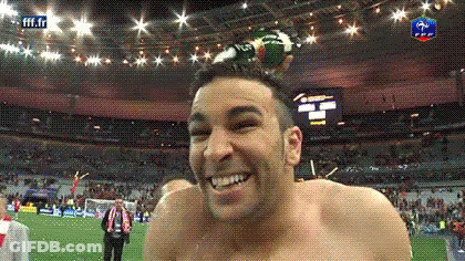 Shirtless Man Smiling As Soccer Ball Flies Overhead GIF