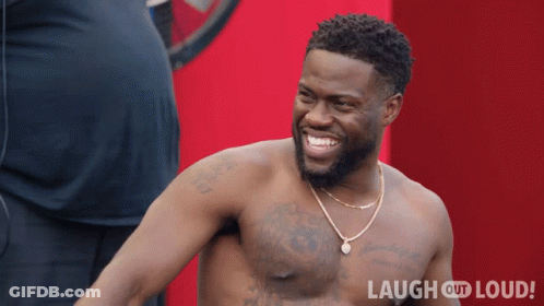 Shirtless Man Smiling In Front Of Red Background Saying Laugh Out Loud GIF