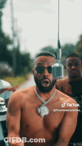 Shirtless Man Standing At Microphone GIF