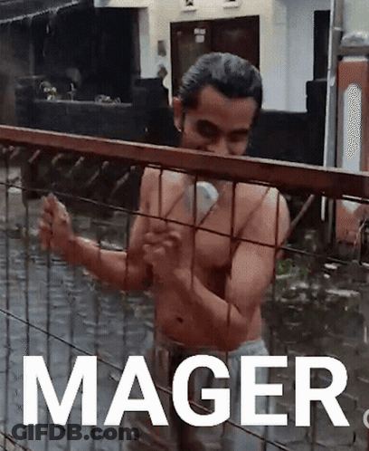 Shirtless Man Standing Behind Flooded Fence With Mager GIF