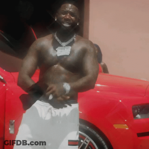 Shirtless Man Standing By Red Car With Open Door GIF