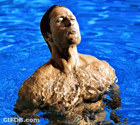 Shirtless Man Standing In Blue Water GIF
