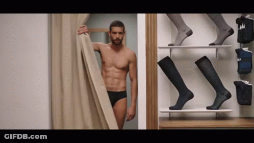 Shirtless Man Standing In Dressing Room GIF