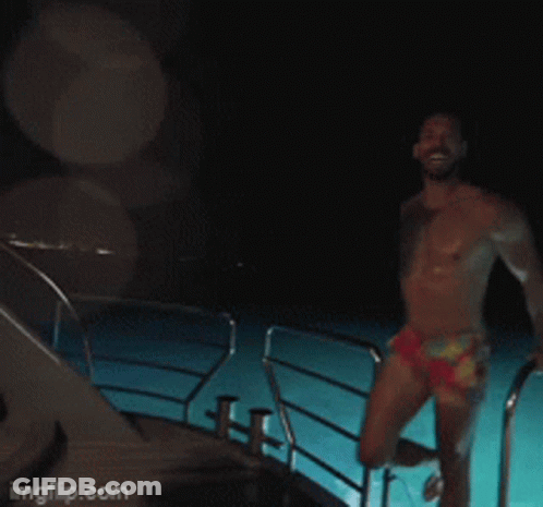 Shirtless Man Standing In Front Of Dom Sign GIF