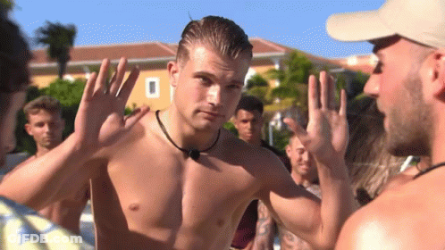 Shirtless Man Standing In Front Of Group GIF